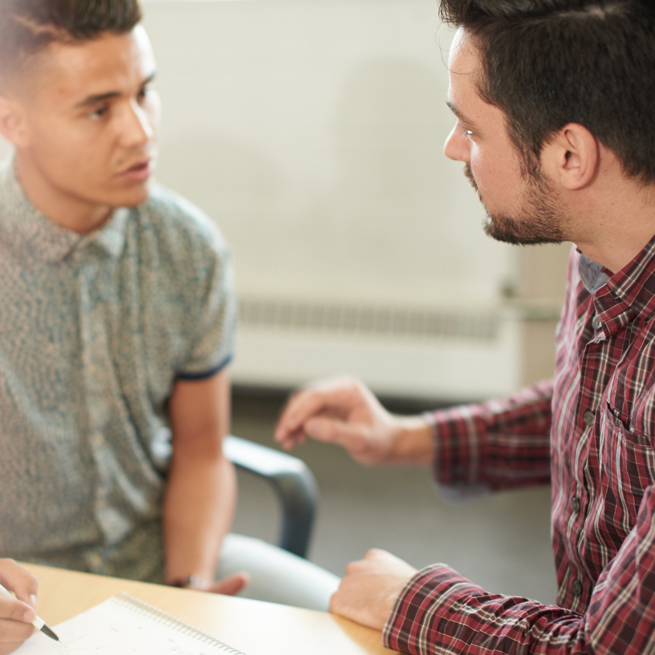 ESL learners sitting at a table speaking