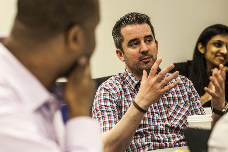 Adult learners discussing as a group in a classroom setting